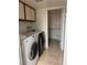 Functional laundry area with modern washer and dryer and storage cabinets at , Las Vegas, NV 89102