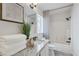 Contemporary bathroom with granite counters, white cabinets, and a shower-tub combination with modern fixtures at 10004 W Cherokee Ave, Las Vegas, NV 89147