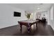 Spacious game room featuring a pool table, hardwood floors, and access to additional living areas at 10004 W Cherokee Ave, Las Vegas, NV 89147