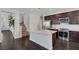 Modern kitchen featuring a large island, stainless steel appliances, and rich hardwood flooring at 10004 W Cherokee Ave, Las Vegas, NV 89147