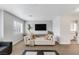 Cozy living room with a daybed, mounted TV, stylish decor, and bright natural light at 10004 W Cherokee Ave, Las Vegas, NV 89147
