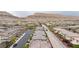 Aerial perspective of an expansive neighborhood with uniform homes and a backdrop of mountains at 10356 Addie De Mar Ln, Las Vegas, NV 89135