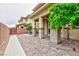 Covered backyard patio area with brick pillars and a lovely outdoor seating arrangement at 10356 Addie De Mar Ln, Las Vegas, NV 89135