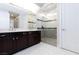 Modern bathroom featuring double vanity, dark wood cabinets and glass enclosed shower at 10356 Addie De Mar Ln, Las Vegas, NV 89135