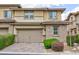 Charming two-story home featuring a two-car garage, brick accents, and well-maintained landscaping in the front at 10356 Addie De Mar Ln, Las Vegas, NV 89135