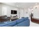 Cozy living room with comfortable seating, a large screen television, and a bright, neutral color palette at 10356 Addie De Mar Ln, Las Vegas, NV 89135
