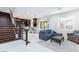 Open concept living area showcasing kitchen, dining and living room with stairs and modern decor at 10356 Addie De Mar Ln, Las Vegas, NV 89135