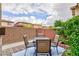Back patio with a table, chairs, and privacy wall with nice landscaping at 10356 Addie De Mar Ln, Las Vegas, NV 89135