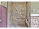 Modern outdoor shower with tile surround, grab bar, and fold-down seat at 10356 Addie De Mar Ln, Las Vegas, NV 89135