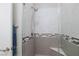 Modern tiled shower with a glass surround, chrome fixtures, and a built-in seat at 10356 Addie De Mar Ln, Las Vegas, NV 89135