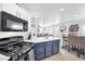 Modern kitchen with white cabinets, a marble counter, and a view into the living room at 10365 Cherokee Corner Ave, Las Vegas, NV 89129