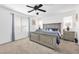 This main bedroom features neutral walls and carpet, a ceiling fan, and a gray bed frame at 10365 Cherokee Corner Ave, Las Vegas, NV 89129