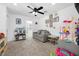 This playroom features a gray sofa, neutral walls and carpet, and an abundance of toys at 10365 Cherokee Corner Ave, Las Vegas, NV 89129
