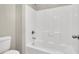 Clean white bathroom featuring a shower-tub combo with tile surround and a modern toilet at 10529 Mount Blackburn Ave, Las Vegas, NV 89166