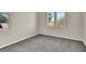 Bright, neutral-toned bedroom with carpet, two windows, and plenty of natural light at 10529 Mount Blackburn Ave, Las Vegas, NV 89166