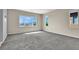 Spacious carpeted bedroom with large windows providing ample natural light and mountain views at 10529 Mount Blackburn Ave, Las Vegas, NV 89166
