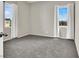 Bright bedroom featuring two large windows with curtains and neutral colors at 10529 Mount Blackburn Ave, Las Vegas, NV 89166