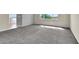Spacious bedroom with a light grey carpet, lots of natural light, and access to multiple rooms at 10529 Mount Blackburn Ave, Las Vegas, NV 89166