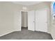 A bright bedroom with a closet, an open door and soft carpet at 10529 Mount Blackburn Ave, Las Vegas, NV 89166