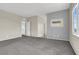 Spacious carpeted bedroom with natural light, neutral paint, and an attached doorway at 10529 Mount Blackburn Ave, Las Vegas, NV 89166