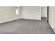 Large carpeted bedroom with neutral walls, bright windows, and an open doorway at 10529 Mount Blackburn Ave, Las Vegas, NV 89166