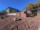 A decorative entrance to a housing community with attractive landscaping at 10529 Mount Blackburn Ave, Las Vegas, NV 89166