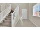 Entryway with carpeted stairs, white banister, and tile flooring at 10529 Mount Blackburn Ave, Las Vegas, NV 89166
