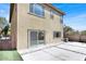 Back of house, featuring pavers, stucco, an ac unit, and sliding glass door at 10529 Mount Blackburn Ave, Las Vegas, NV 89166
