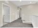 Hallway with neutral walls, access to bathroom, and white railing stairs at 10529 Mount Blackburn Ave, Las Vegas, NV 89166