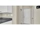 Hallway with access to front door and adjacent to kitchen with granite counters at 10529 Mount Blackburn Ave, Las Vegas, NV 89166
