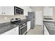 Well-equipped kitchen with stainless steel appliances, granite countertops, and white cabinets at 10529 Mount Blackburn Ave, Las Vegas, NV 89166