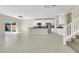 Open-concept living space featuring tile floors, large windows, and a modern kitchen at 10529 Mount Blackburn Ave, Las Vegas, NV 89166