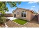 Charming backyard with a cozy patio, well-kept gravel, and partial artificial turf at 10540 Beachwalk Pl, Las Vegas, NV 89144