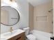 Bright bathroom featuring a white vanity with gold fixtures and tiled shower/tub combo at 10540 Beachwalk Pl, Las Vegas, NV 89144