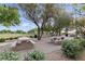 Park with inviting picnic tables and walking paths surrounded by lush greenery at 10540 Beachwalk Pl, Las Vegas, NV 89144