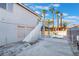 The backyard offers a serene escape with a pool view, mature palms, upper deck, and a spacious patio at 108 Appian Way, Henderson, NV 89002