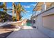 A view of the backyard area with a sparkling pool and patio, framed by mature palm trees at 108 Appian Way, Henderson, NV 89002