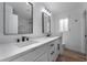 Beautiful bathroom with dual sinks, quartz counters, modern fixtures, and framed mirrors at 108 Appian Way, Henderson, NV 89002