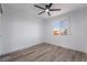 Well-lit bedroom features a ceiling fan, hardwood floors, and a large window with a beautiful view at 108 Appian Way, Henderson, NV 89002