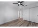 Bedroom with ceiling fan, hardwood floors, and a closet, offering comfort and convenience at 108 Appian Way, Henderson, NV 89002