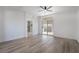 Large bedroom with fan, wood-look floors, access to covered patio and shower at 108 Appian Way, Henderson, NV 89002