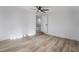 Spacious room with ceiling fan and wood-look floors leading to stairs at 108 Appian Way, Henderson, NV 89002