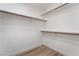 Walk-in closet with built-in shelving and wood-look floors at 108 Appian Way, Henderson, NV 89002
