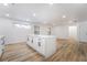Open kitchen featuring a large island with sleek countertop, recessed lighting, and modern finishes at 108 Appian Way, Henderson, NV 89002
