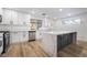 Well-lit kitchen featuring a large island with stone countertop, modern fixtures, and white cabinets at 108 Appian Way, Henderson, NV 89002
