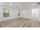 Spacious living room featuring modern wood-look floors, bright windows, and neutral decor at 108 Appian Way, Henderson, NV 89002