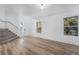 Bright living room featuring sleek wood-look floors, fresh white walls, and plenty of natural light at 108 Appian Way, Henderson, NV 89002