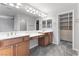 Bright bathroom boasts double sink vanity and large mirror with great storage at 11408 Newton Commons Dr # 104, Las Vegas, NV 89135