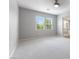 Bright bedroom features two windows and neutral carpeting, adjacent to a bathroom at 11408 Newton Commons Dr # 104, Las Vegas, NV 89135