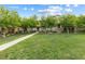 Townhome exterior with lawn and trees enhancing the community's appeal at 11408 Newton Commons Dr # 104, Las Vegas, NV 89135